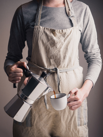 Geyser coffee maker with cup in armsの写真素材