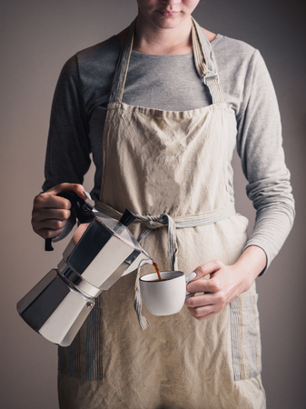 Geyser coffee maker with cup in armsの写真素材