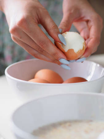 Breakfast with oatmeal and eggs. White table.の写真素材