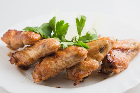 chicken wings with greens on the plate.の写真素材