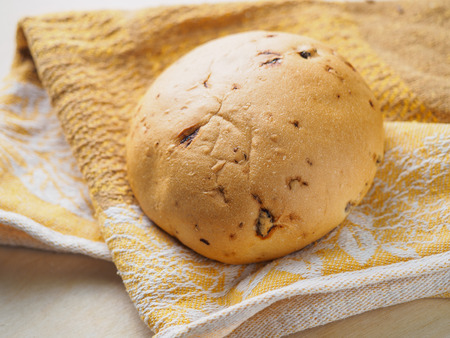 Sweet loaf of bread on a table.