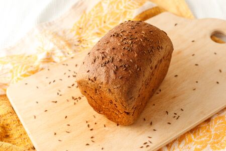 loaf of black bread on a table.