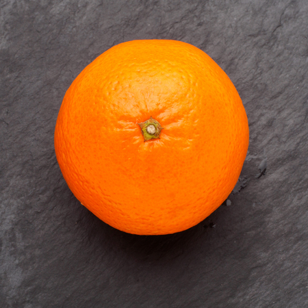 exotic vitamin orange fruit round on black isolated background.の写真素材