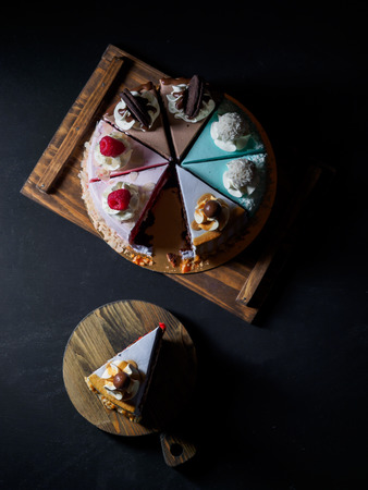 Set of pieces cakes on black background.の写真素材
