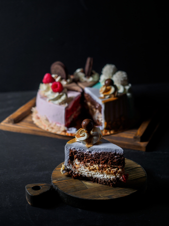 Set of pieces cakes on black background.の写真素材
