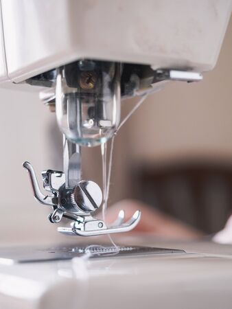 Girl working on sewing machine with textile napkins.