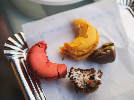 Red and yellow macarons at pepper on food market.