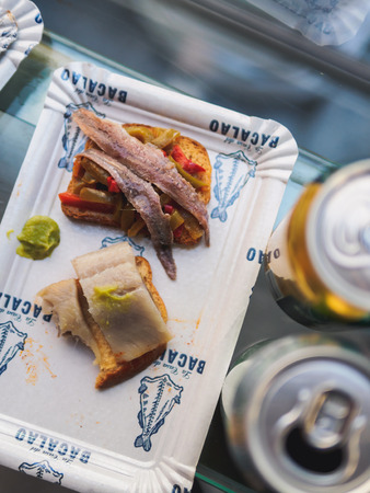 Barcelona, Spain - September 22, 2017. Tapas with fish in pepper plate on food market. La Boqueria public market.の写真素材