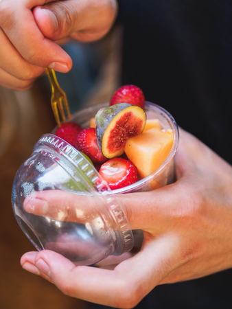 Street food fruits in plastic cup. pineapple fig strawberry.の写真素材