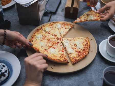 Lifestyle pizza party of friends. grey table.の写真素材