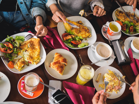 Lifestyle breakfast people friends hands in cafe.