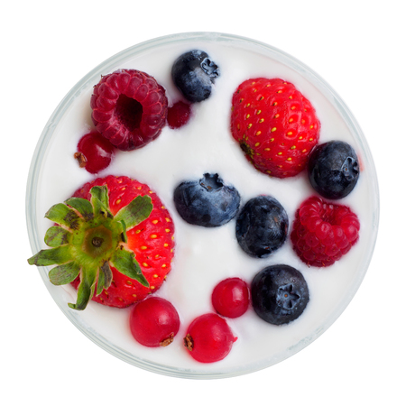 Glass with berries in milk. isolated background.の写真素材