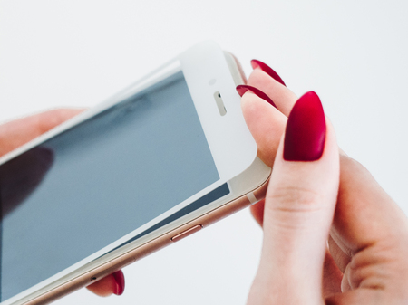 Smartphone with screen protect glass cover in hands. White background.の写真素材