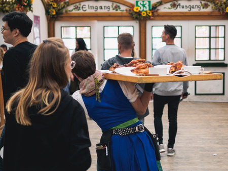 MUNICH, GERMANY - OCTOBER 2, 2017: Crowds in Beer Tent on the Theresienwiese Oktoberfest fair grounds.のeditorial素材