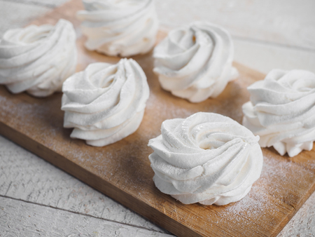 White homemade zephyr on the wooden board.の写真素材