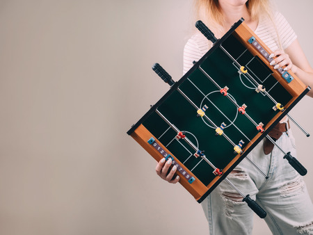 Mini table football foosball soccer in girl hands.の写真素材