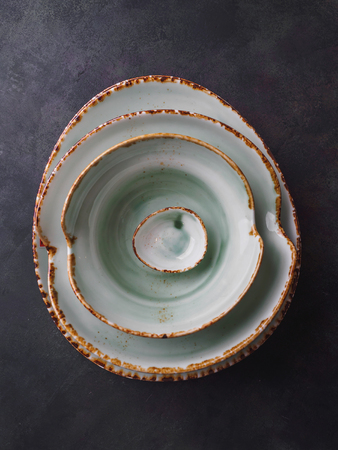 Set of modern tableware plates at black table.の写真素材