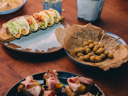 Snacks tacos on the bar table in cafe.