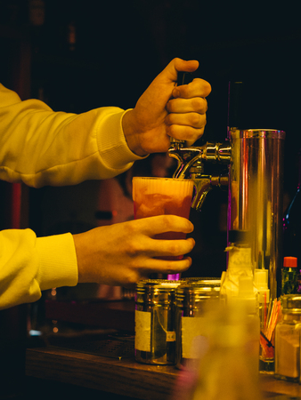 Cocktail in glass in hand.