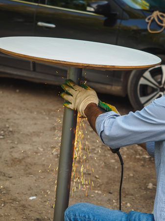 Industrial worker at the street welding closeup.の写真素材