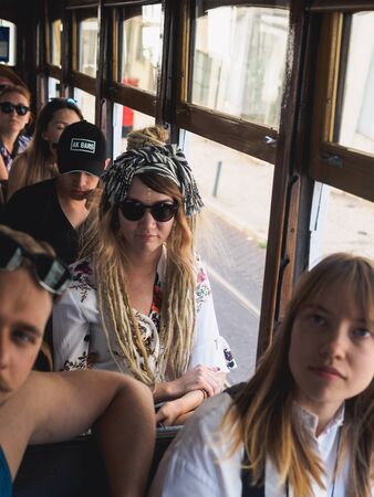 Lisbon, Portugal - SEPTEMBER 24 2017: Tourists with vintage carriage tram on famous 28 line in Lisbon.のeditorial素材