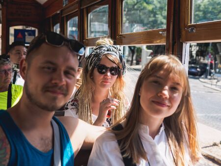 Lisbon, Portugal - SEPTEMBER 24 2017: Tourists with vintage carriage tram on famous 28 line in Lisbon.のeditorial素材