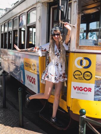 Lisbon, Portugal - SEPTEMBER 24 2017: Tourists with vintage carriage tram on famous 28 line in Lisbon.のeditorial素材
