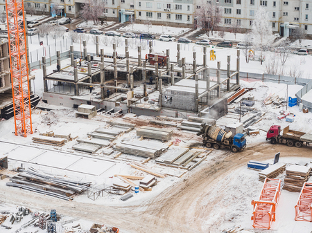Crane and building construction. Winter air view