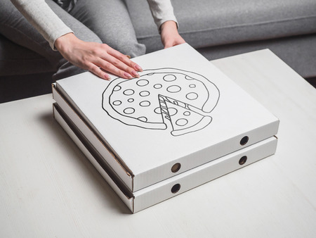 Girl open pizza delivery box with illustration.の写真素材