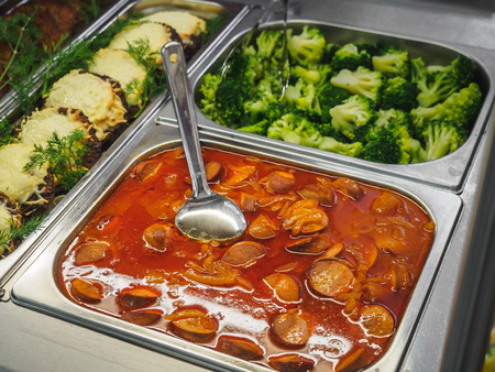 Cuisine cafeteria buffet with food. Self-service food display showcase.の写真素材