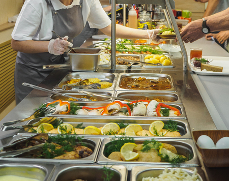 Cuisine cafeteria buffet with food. Self-service food display showcase.の写真素材