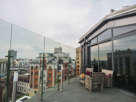 Sky cafe on the roof terrace with view of modern city.