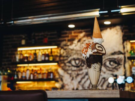 Chocolate freak shake with ice cream, brezel, cake and whipped cream.の写真素材