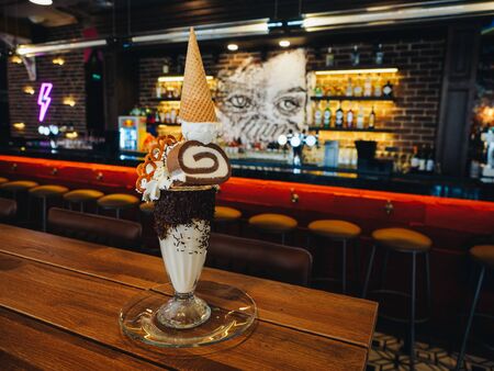 Chocolate freak shake with ice cream, brezel, cake and whipped cream.