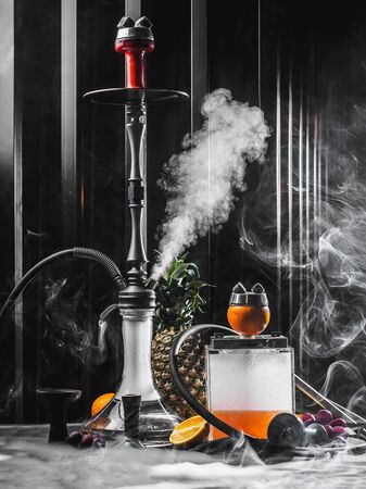 Modern smoky hookah with orange and pineapple.