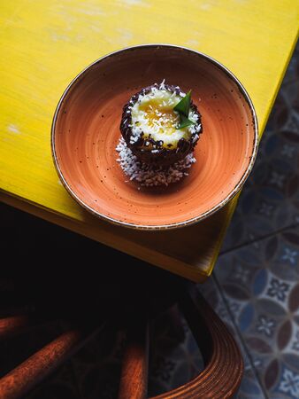 Chocolate coconut pineapple round dessert. Yellow table.の写真素材
