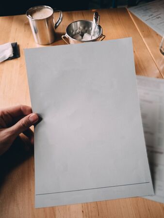 Hand with cafe restaurant menu. Mock up copy space.の写真素材