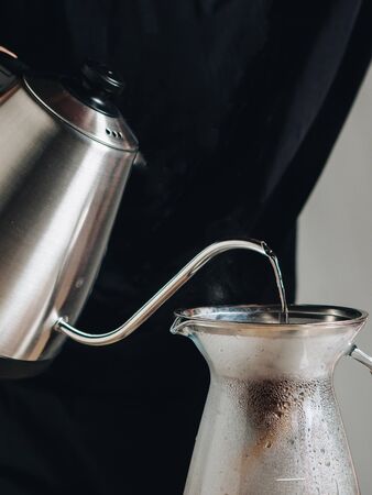 Making of filter coffee with kettle for brewing.
