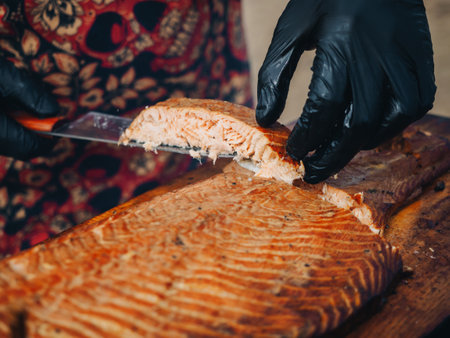 BBQ grilles salmon steak on wooden desk. fire background.