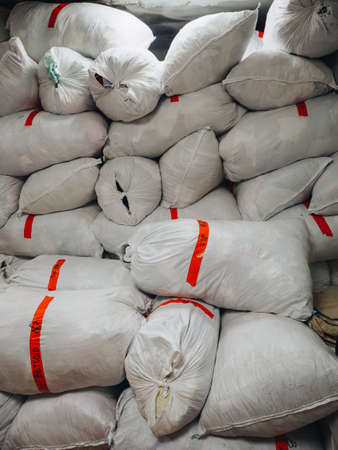 Warehouse of bags with clothes shoes textile fabrics.