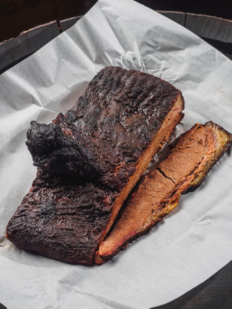 Sliced piece of beef brisket on white paper.の写真素材