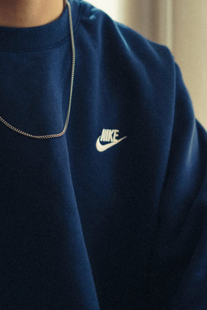 Close up of a man's hand wearing a blue hoodie.の写真素材