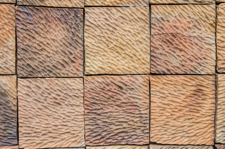 Abstract pattern of an old red, orange and black brick wall with lots of texture useful for...