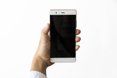 Isolated female hand holding a phoneの写真素材