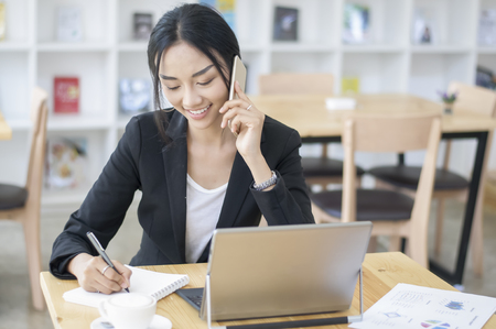 A business woman working on the laptop at the officeの写真素材