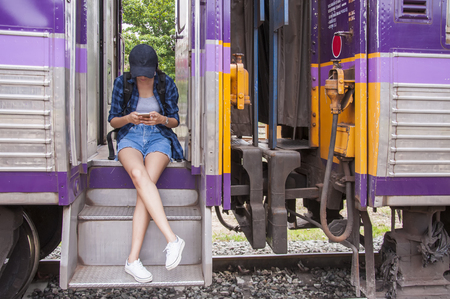 beautiful young asian girl traveling alone at train stationの写真素材