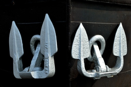 Pair of silver anchors on black backgroundの写真素材