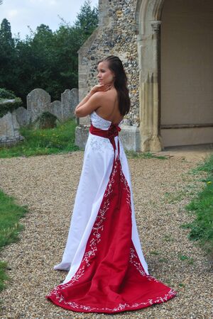 bride outside in red and white dressの写真素材