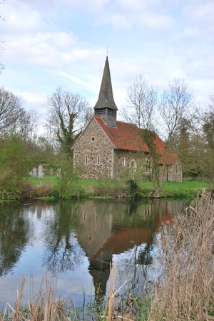 small church reflecting in riverの写真素材