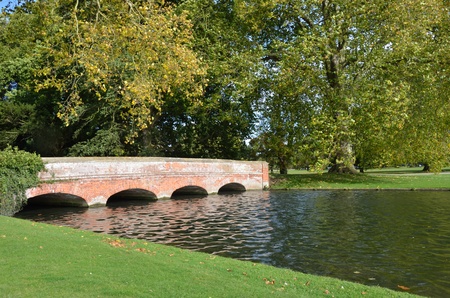 Red brick bridge in formal gardenの写真素材